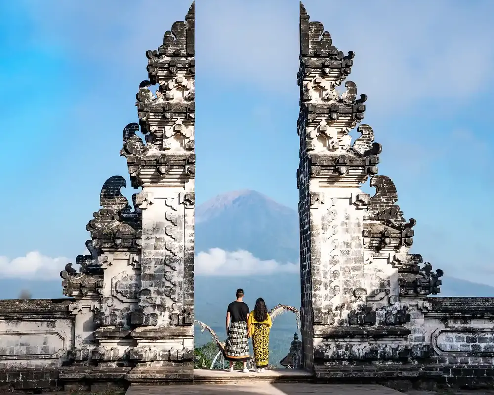 A split temple gate with a volcano between its two towers