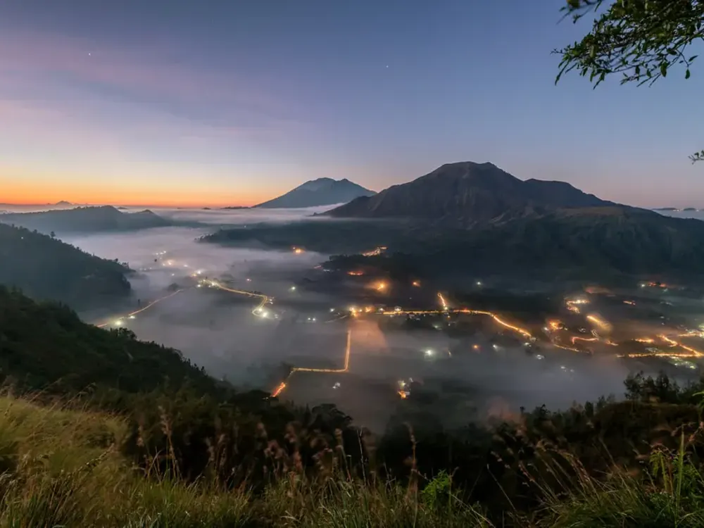Sunrise over the Kintamani caldera with mist in the valley